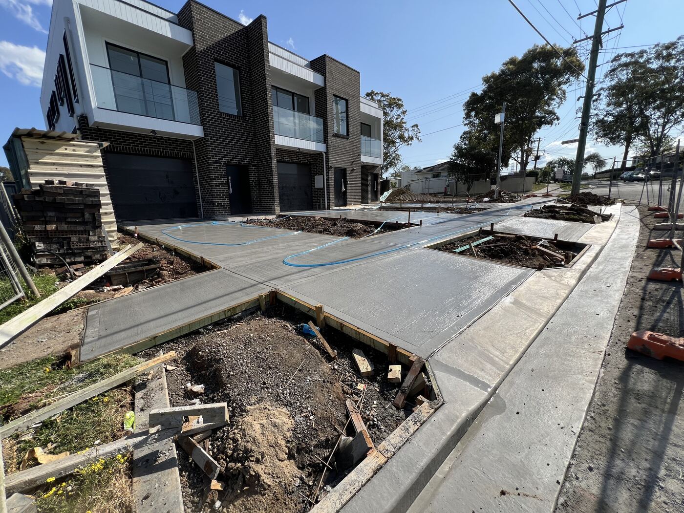 Concrete driveway pour in progress with control lines
