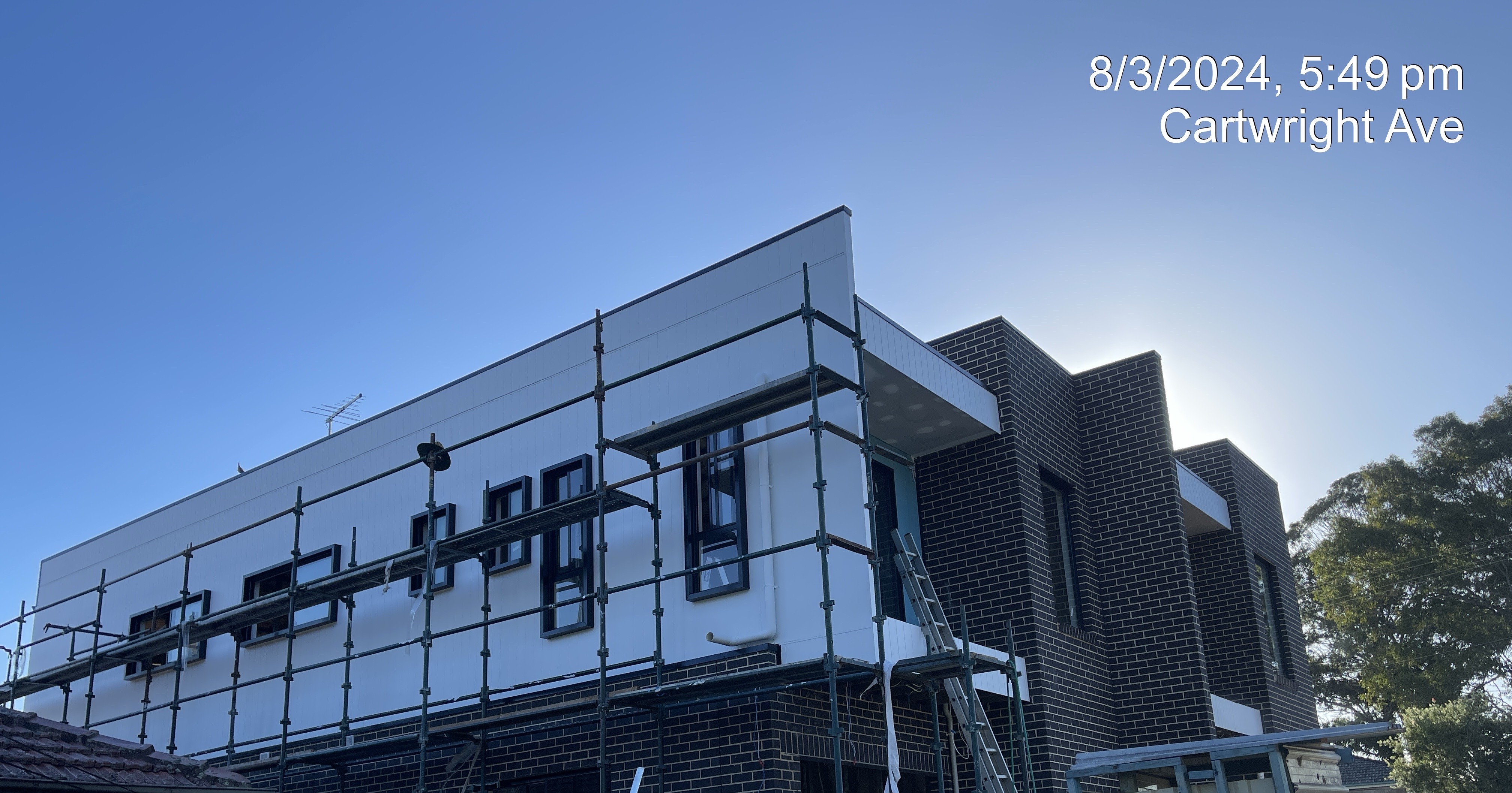 Duplex development on scaffolding with cladding and brick, Cartwright Ave