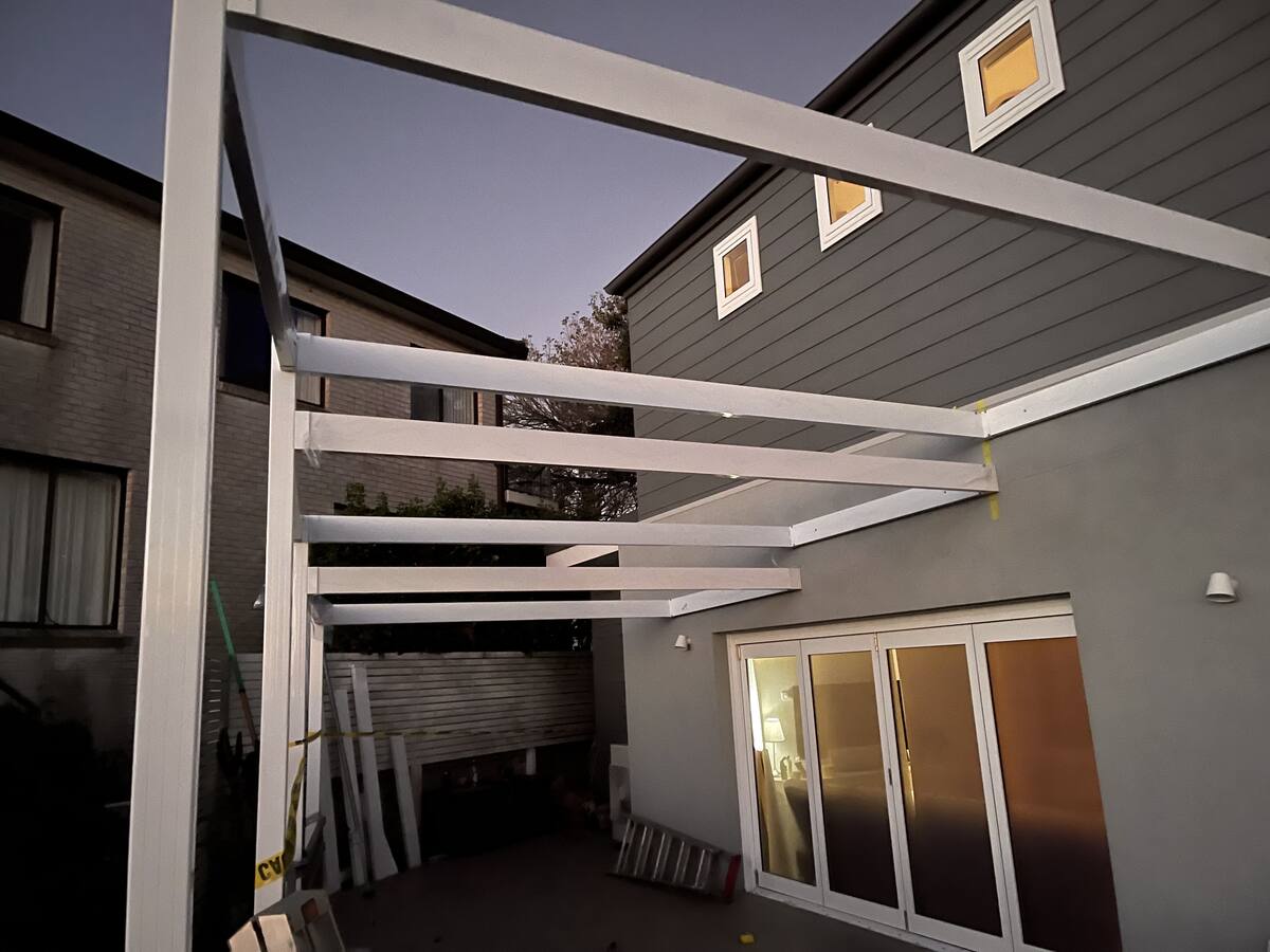 Aluminium pergola frame under construction at dusk